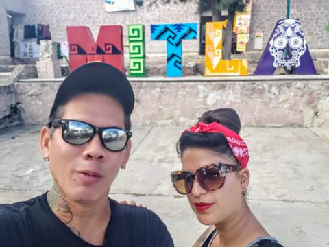 A man and a woman pose for a selfie in front of large, colorful decorative letters. MJ and Cisco, San Pablo Villa de Mitla, Mexico, November 2, 2019
