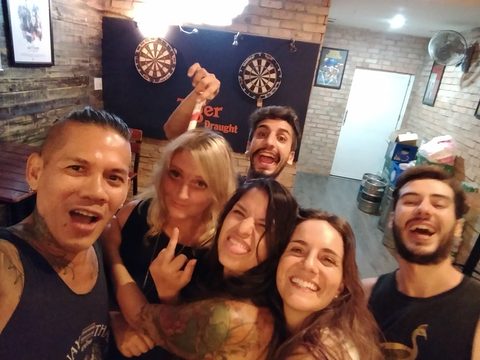 A group of friends are smiling and making playful faces for a selfie in a dimly lit pub. MJ and Cisco and Katrina and Rama, Quan Hai, Vietnam, September 17, 2017