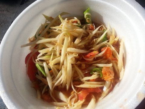 A white bowl filled with a colorful shredded papaya salad. Khlong Toei, Thailand, May 28, 2015